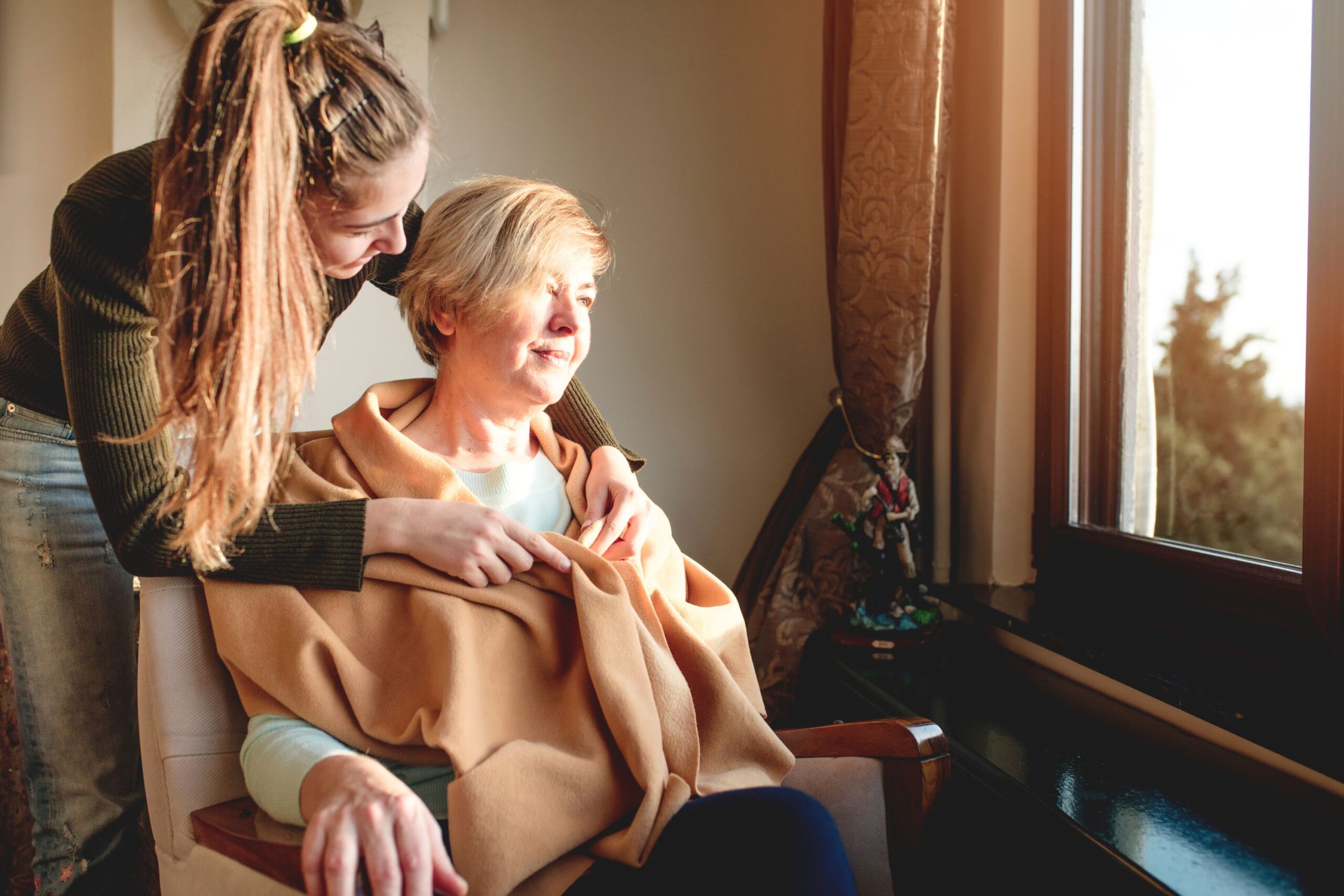 Woman help her mother with her scarf
