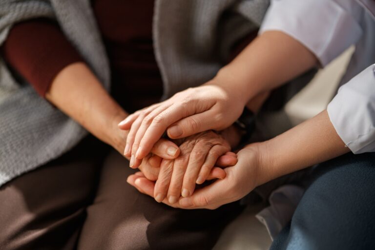Two people with their hands together